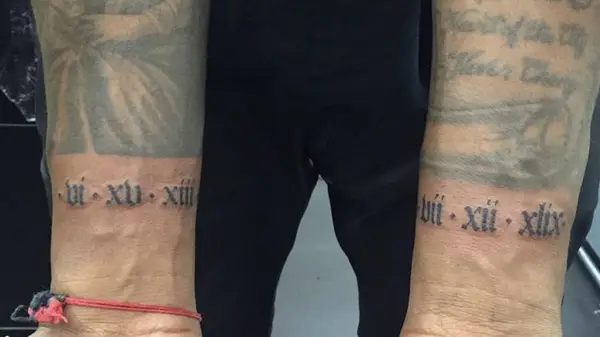 Kanye West with dates tattooed on wrists