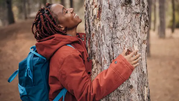 Person hugging tree