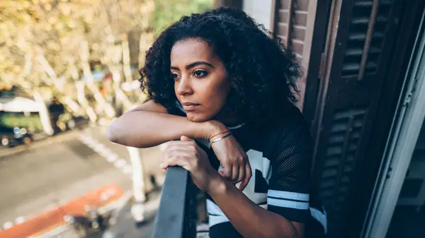 woman looking out from window