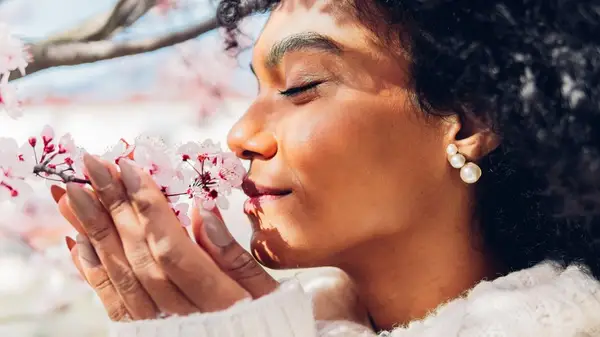 Person smelling flowers