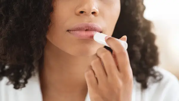 Applying lip balm