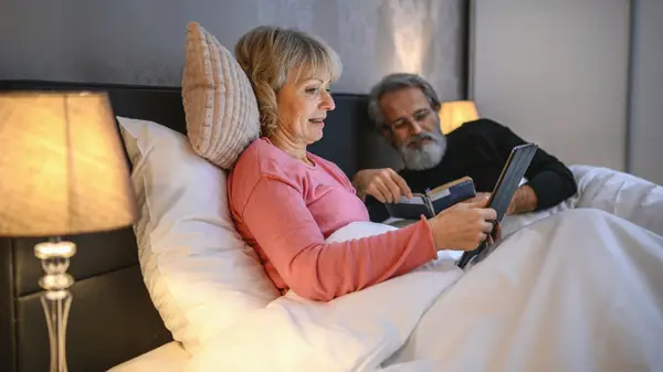 Couple reading in bed