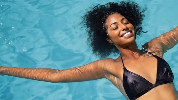 Woman backfloating in pool