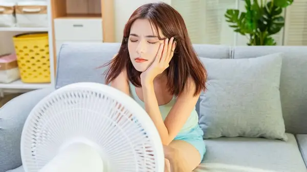 Woman in front of fan