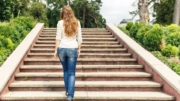 Person walking up stairs outside