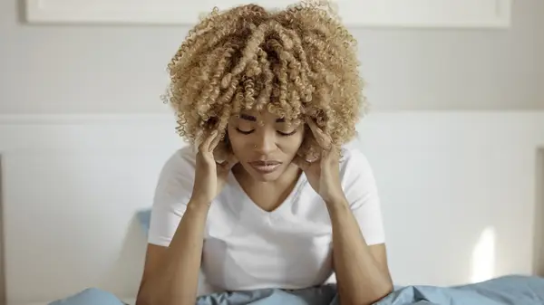 woman holding her head