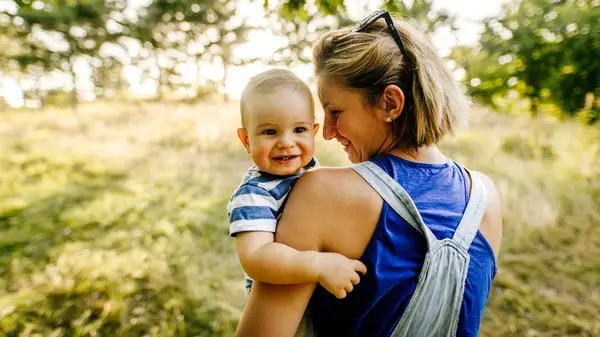 Mom holding baby outside