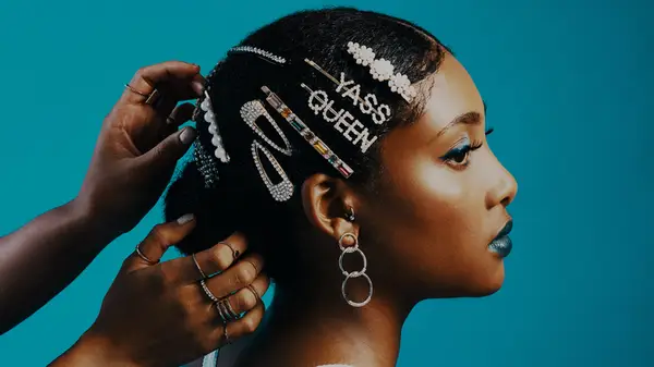 Black woman getting her hair styled