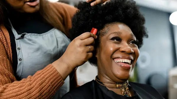 Woman getting hair styled