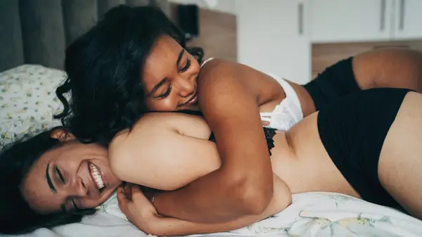 Women wearing bras in bed