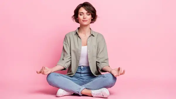 Woman meditation against pink background
