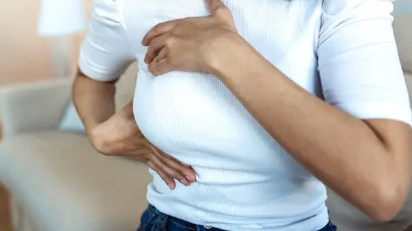 Woman holding her breast