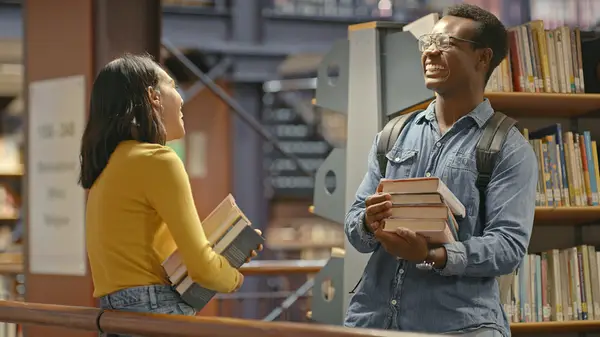Man and woman at library laughing