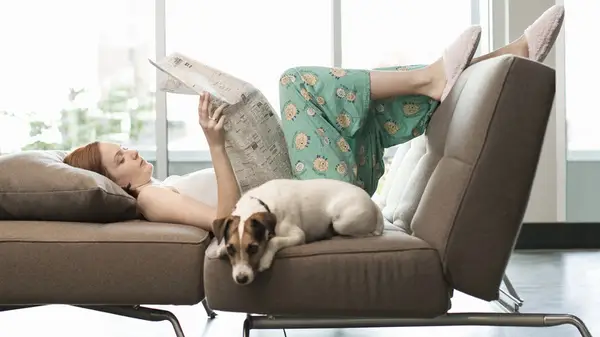 Woman on couch with dog