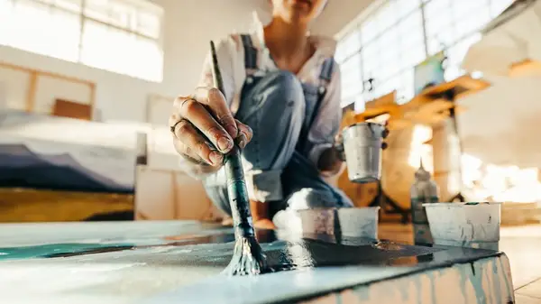 Person putting stickers in a book