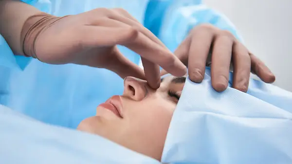 Surgeon touching woman