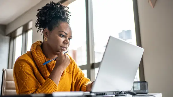 Woman researching on a laptop