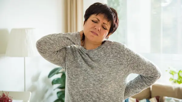 Woman suffering from back pain.