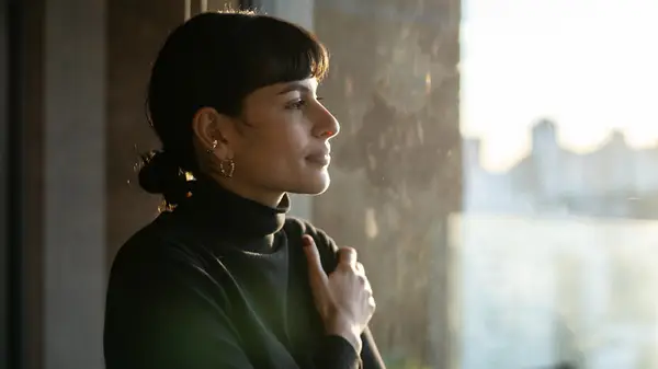 Woman looking out window