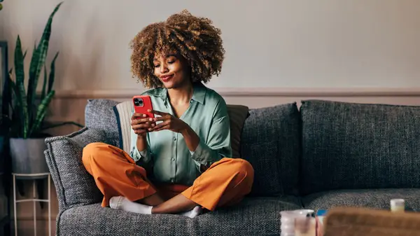Woman texting on couch