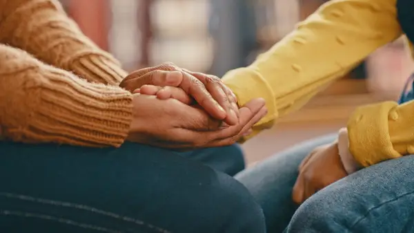 showing suport by handholding