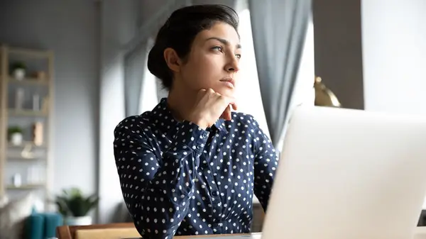 Woman looking out window