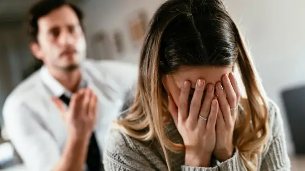 Man trying to talk to crying woman