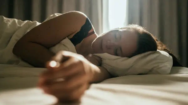 A woman in bed in the dark