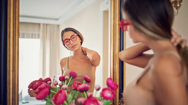 Woman looking at herself in mirror