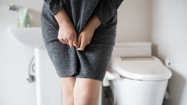 Woman holding groin area