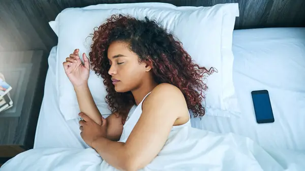 women sleeping by phone