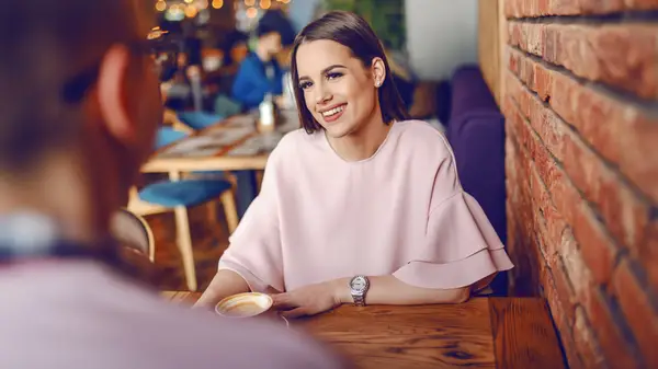 Woman on a date, smiling and seated