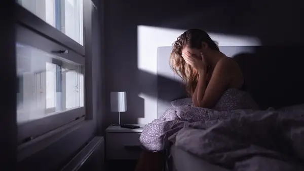 Depressed woman in bed 
