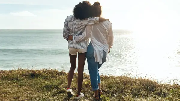 Friends looking out at coast 