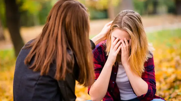 Friend consoling her friend 