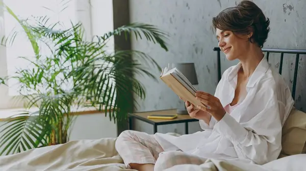 Woman reading in bed